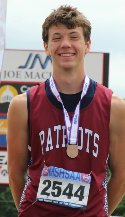 Boy smiling on podium. 
